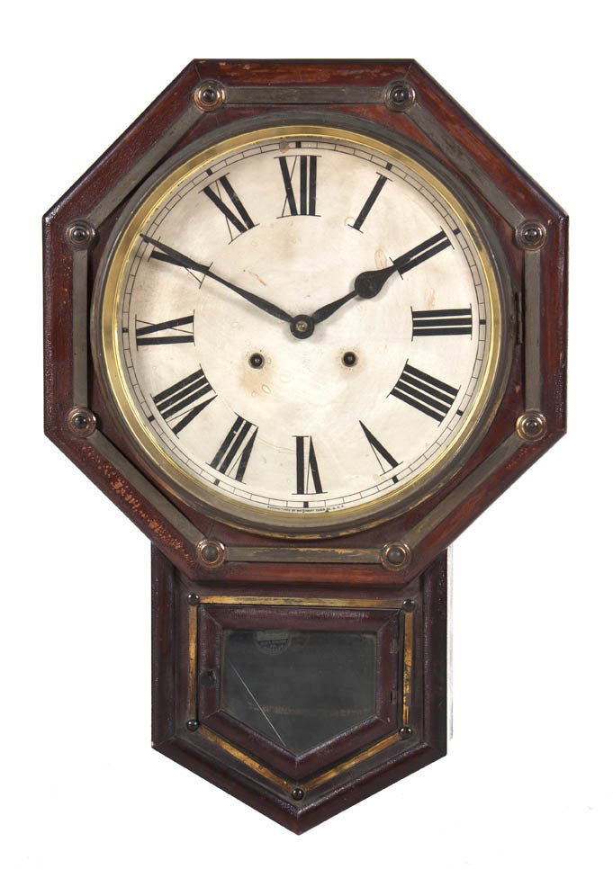 An American Wall Clock, Waterbury, Height 24 inch: An American Wall Clock, Waterbury, the octagonal frame centered with a circular dial having Roman numerals. Height 24 inches.