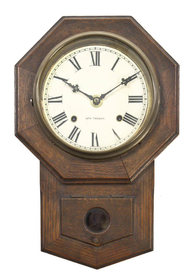 An American Wall Clock, Seth Thomas, Height 17 3/: An American Wall Clock, Seth Thomas, the circular dial with Roman numerals. Height 17 3/4 x width 11 3/4 inches.