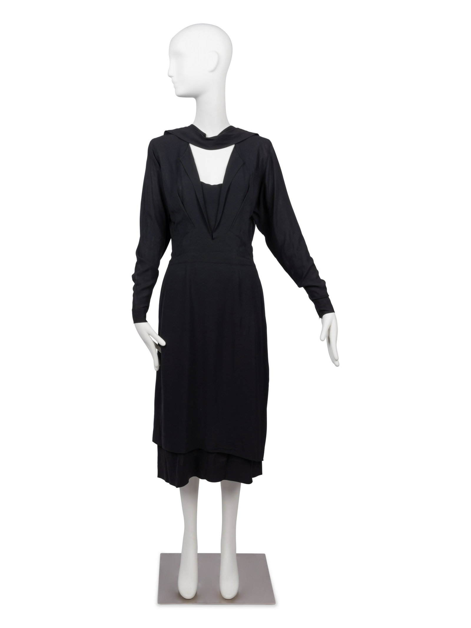 Adrian Dress, 1940s: Adrian Dress, 1940s Long black crepe dress with draped neckline, open center front, shoulder pads, long sleeves, and an intricate center front pattern of a lapel falling into a hip yoke. The skirt is 