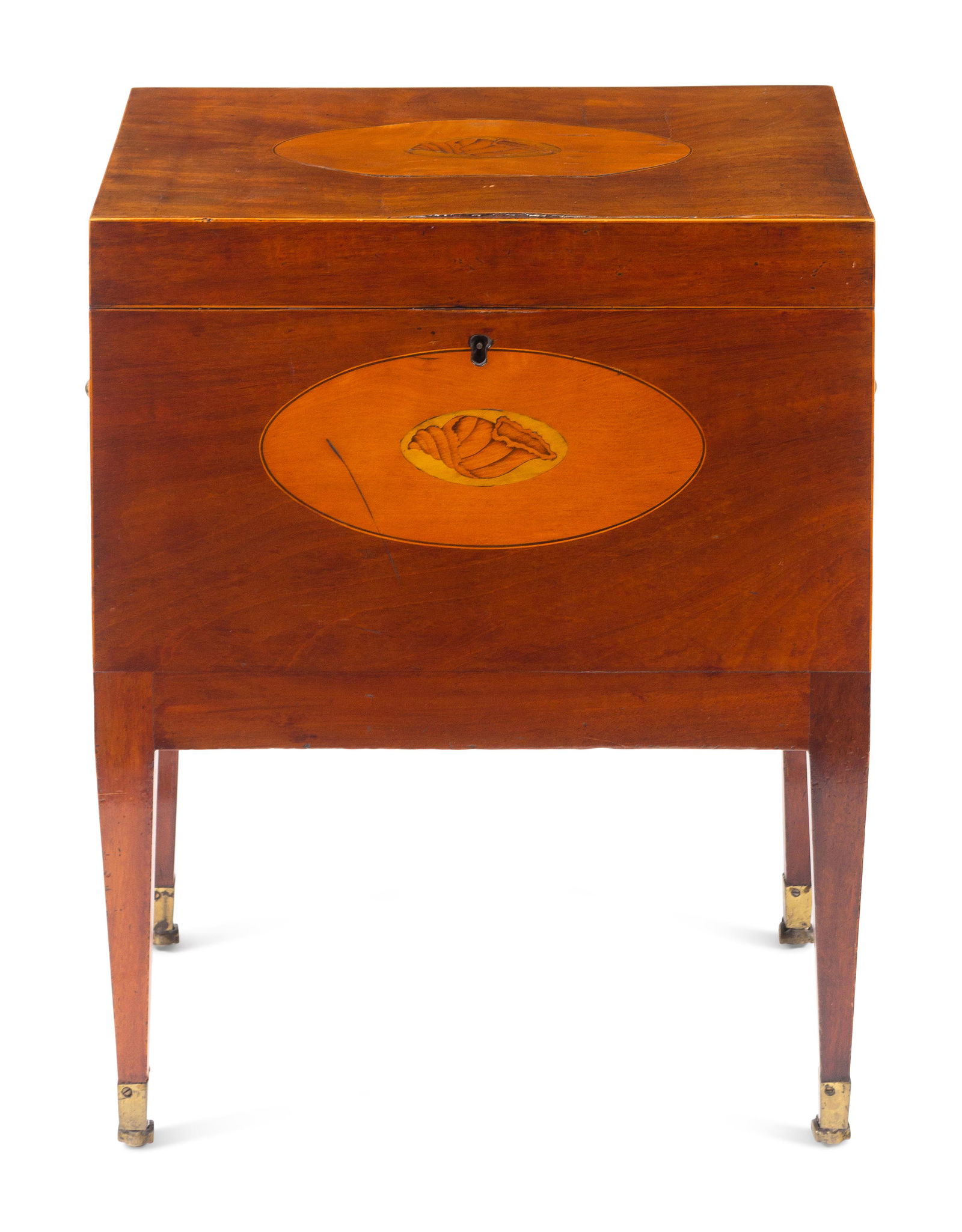 A George III Mahogany, Satinwood and Marquetry Cellarette: A George III Mahogany, Satinwood and Marquetry Cellarette Circa 1790 the hinged lid inlaid with a shell and opening to a vacant interior; on casters. Height 22 3/4 x width 18 x depth 11 inches. This l