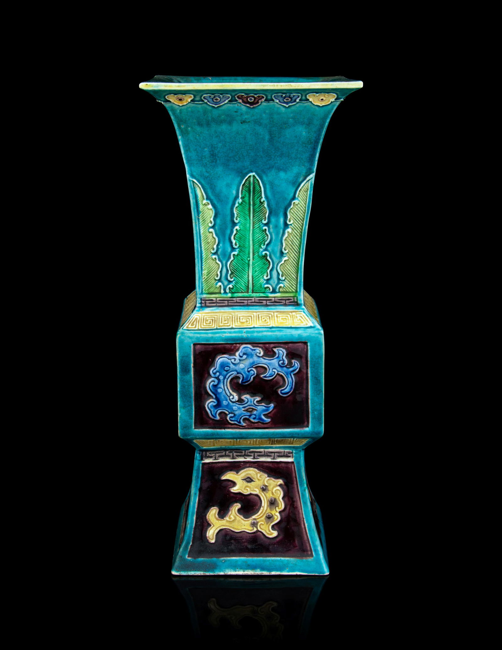 A Fahua-Style Porcelain Gu Vase: A Fahua-Style Porcelain Gu Vase 19th Century 清晚期 法華龍紋觚 each of archaistic gu form, square sectioned, decorated with blue and yellow dragon motif