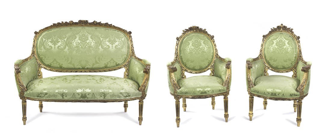 A Louis XVI Style Giltwood Parlor Suite, Height of: A Louis XVI Style Giltwood Parlor Suite, comprising a settee and two armchairs, each with upholstered back, sides and seat within a floral and leaf carved frame, raised on tapering fluted legs. Height