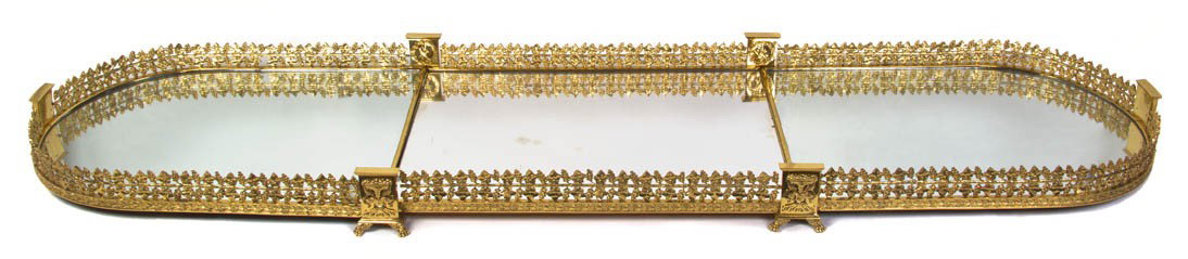 A Neoclassical Gilt Bronze Surtout de Table au Bac: A Neoclassical Gilt Bronze Surtout de Table au Bacchus, in three parts having rounded ends, the whole cast with a pierced grapevine gallery over the mirrored surface, raised on cast paw feet. Width 64