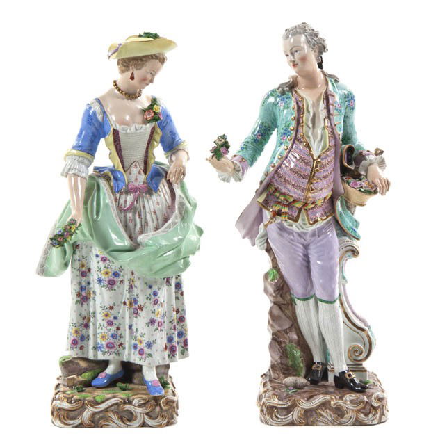 A Pair of Meissen Porcelain Figures, Height of tal: A Pair of Meissen Porcelain Figures, depicting a gentleman and a lady in 18th century attire, each holding flowers and raised upon a naturalistic base, having crossed swords marks in underglaze blue,