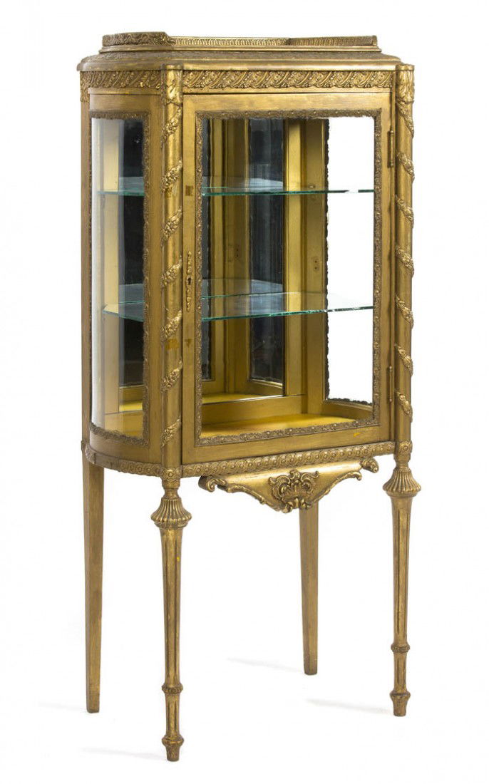 A Neoclassical Style Giltwood Vitrine Cabinet, Hei: A Neoclassical Style Giltwood Vitrine Cabinet, having a three-quarter galleried top over a single glazed door opening to a glazed interior, raised on baluster form legs. Height 53 x width 26 x depth 1