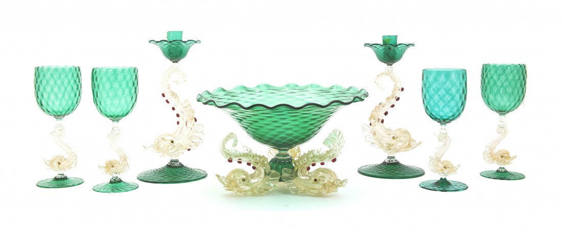 A Venetian Glass Table Garniture and Stemware Set,: A Venetian Glass Table Garniture and Stemware Set, each in green glass with an internally gilt decorated dolphin form stem, comprising a center bowl, four candlesticks and fifteen stems, together with