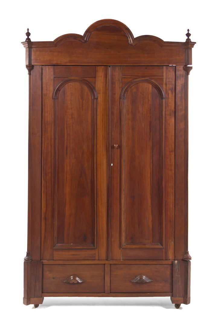 An American Cherry Knock Down Armoire, Height 88 3: An American Cherry Knock Down Armoire, having an arched and molded cornice over the rectangular case having two handled doors above two drawers, raised on block feet ending in casters. Height 88 3/4 x