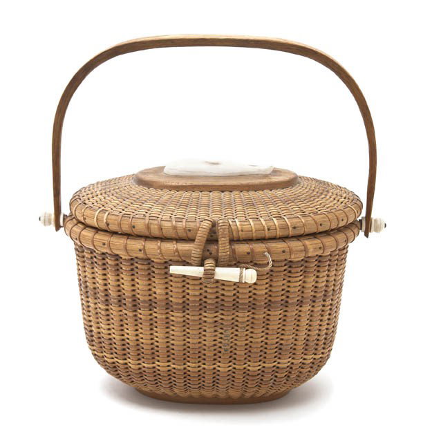 A Nantucket Purse Basket, Mike Kane, Width 10 inch: A Nantucket Purse Basket, Mike Kane, having a swing handle over the hinged lid centered with a carved ivory whale over the oval body, marked Made By Mike Kane 1975 Nantucket Island. Width 10 inches. P