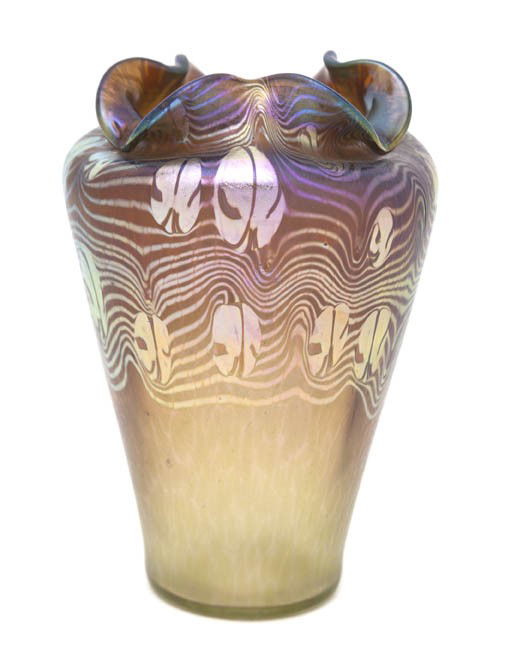 An Austrian Iridescent Glass Vase, in the Manner o: An Austrian Iridescent Glass Vase, in the Manner of Loetz, of tapering form, with a ruffled rim and pulled linear decoration. Height 7 inches.