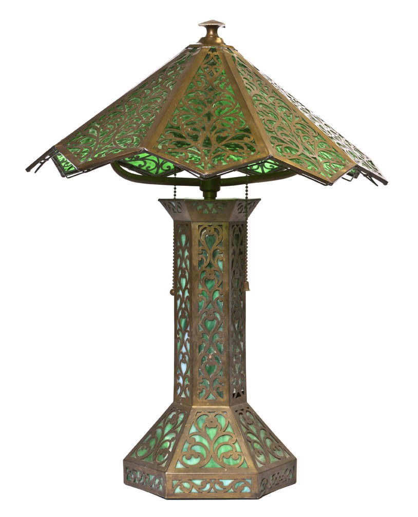 An American Slag Glass Table Lamp, after a design: An American Slag Glass Table Lamp, after a design by Riviere Studios, the domed shade having nine panels raised on a columnar stem ending in a hexagonal base, with pierced scrolling metalwork througho