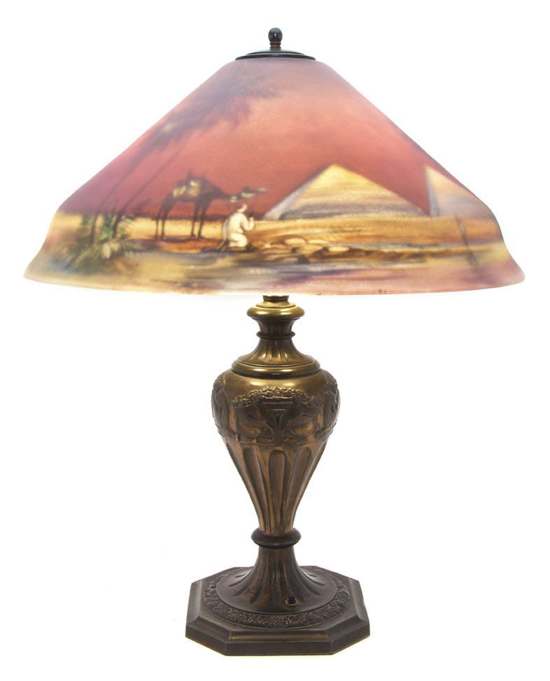 A Pairpoint Reverse Painted and Cast Metal Table L: A Pairpoint Reverse Painted and Cast Metal Table Lamp, the Garden of Allah shade signed F. Guba and raised on an urn form base cast with mythical beasts and epergnes of fruit over a stepped octagonal