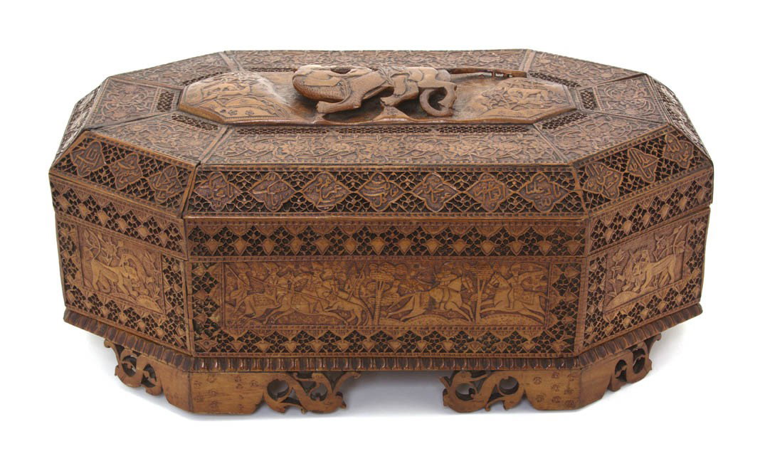 A Middle Eastern Carved Wood Box, Width 14 1/4 inc: A Middle Eastern Carved Wood Box, of octagonal form, decorated with hunting scenes and foliate motifs. Width 14 1/4 inches.