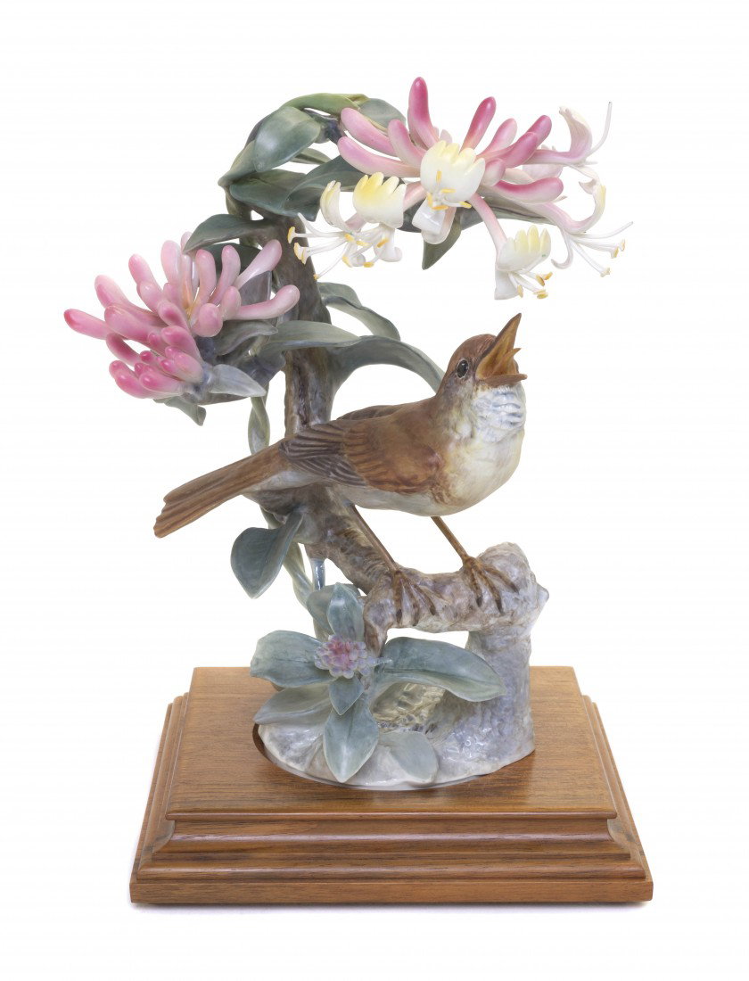 A Royal Worcester Dorothy Doughty Bird, Nightingal: A Royal Worcester Dorothy Doughty Bird, Nightingale, perched on honeysuckle. Height 10 1/2 inches.