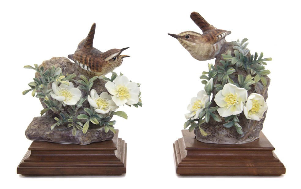 A Royal Worcester Dorothy Doughty Bird, Burnette W: A Pair of Royal Worcester Dorothy Doughty Birds, Burnette Wren, perched on a naturalistic rocky base with wild rose. Height 5 1/2 inches.