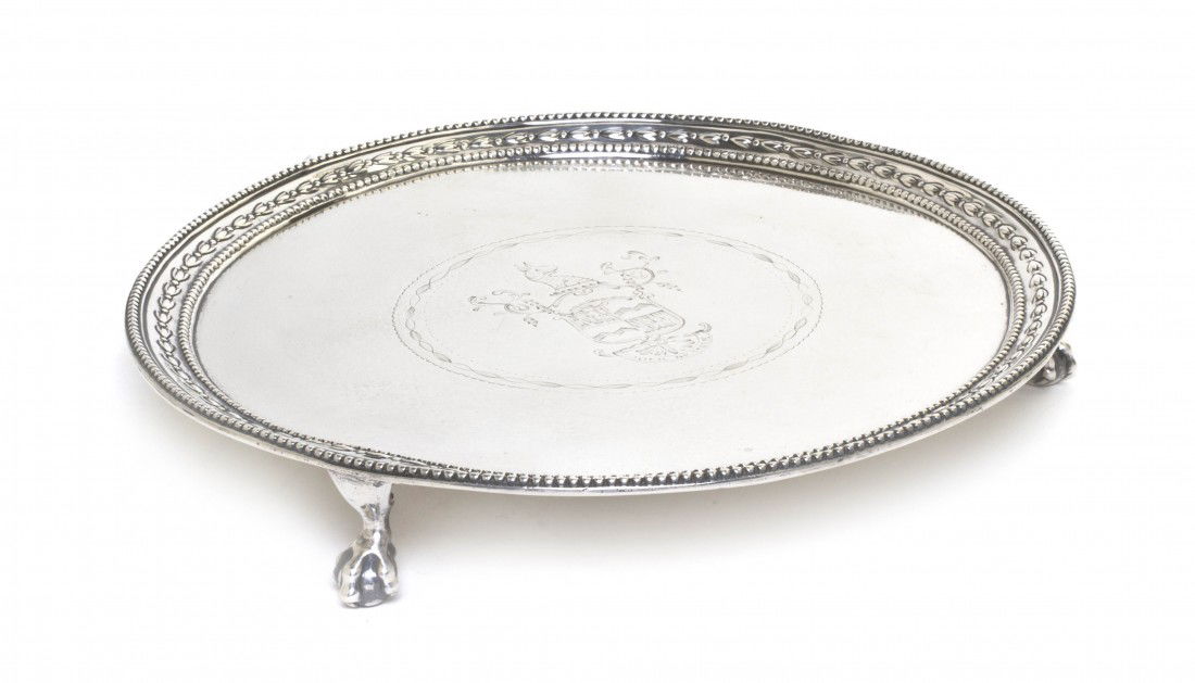 An English Silver Salver, Richard Rugg I, Diameter: An English Silver Salver, Richard Rugg I, London, 1779, of circular form, having a coat-of-arms at the center, raised on claw and ball feet; approximate total weight 12.55 ozt. Diameter 8 inches.
