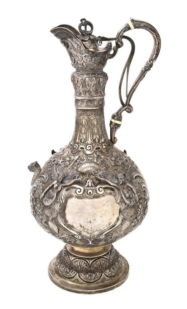 An English Silver Ewer, Walter, John, Michael, Sta: An English Silver Ewer, Walter, John, Michael, Stanley Barnard & Robert Dubock, London, 1897, having an applied handle with ivory insulators and a gilt interior, the body with bands of foliate decorat