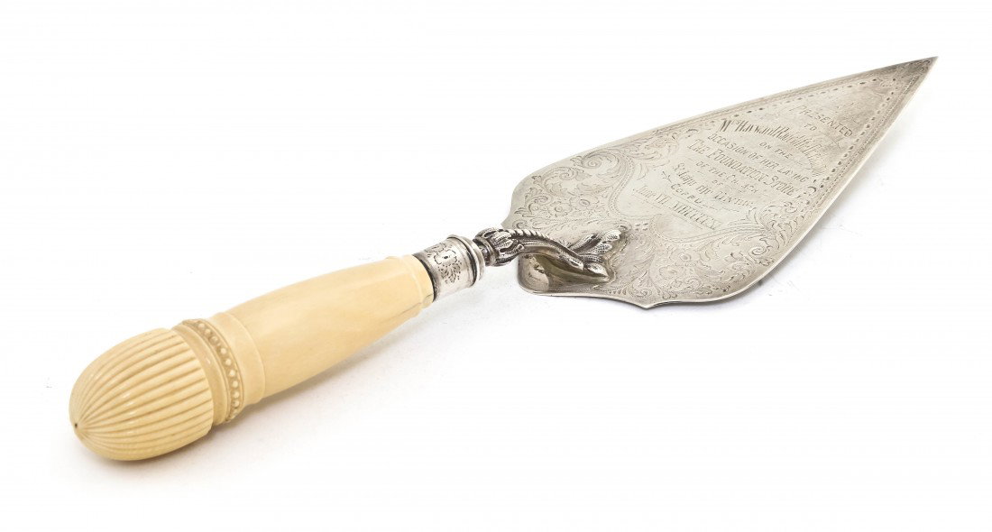 An English Silver and Ivory Presentation Mason's T: An English Silver and Ivory Presentation Mason's Trowel, Elkington & Co Ltd., Birmingham, 1904, having bright cut decoration, the inscription reading Presented to Mrs. Hayward Radcliffe Darlington on 
