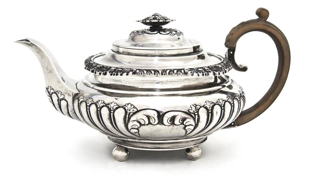 An English Silver Teapot, George Burrows II, Width: An English Silver Teapot, George Burrows II, London, 1824, of squat baluster form having a floriform finial over the circular hinged lid above a border with shell and gadrooned decoration, the body wi