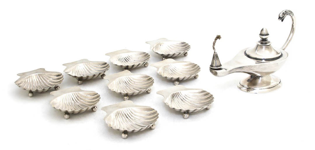 A Mexican Sterling Silver Assembled Smoking Set, : A Mexican Sterling Silver Assembled Smoking Set, Maciel, comprising a cigar oil lamp and nine shell form ash receivers; approximate total weight overall 12.98 ozt. Width of first 6 inches.