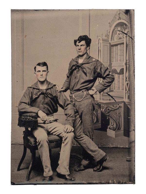 [EARLY PHOTOGRAPHY - NAVY]. A group of 7 ambrotypes and tintypes of sailors, including:: [EARLY PHOTOGRAPHY - NAVY]. A group of 7 ambrotypes and tintypes of sailors, including: A loose sixth plate tintype of a pair of postwar sailors, one seated and one standing, posed before a painted ba