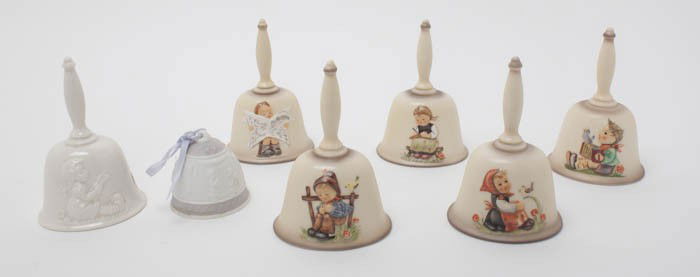A Collection of Nineteen Hummel Porcelain Annual: A Collection of Nineteen Hummel Porcelain Annual Bells, comprising various years, shapes and sizes, together with a Lladro 1995 Christmas bell and a clock. Height of tallest 6 1/4 inches.