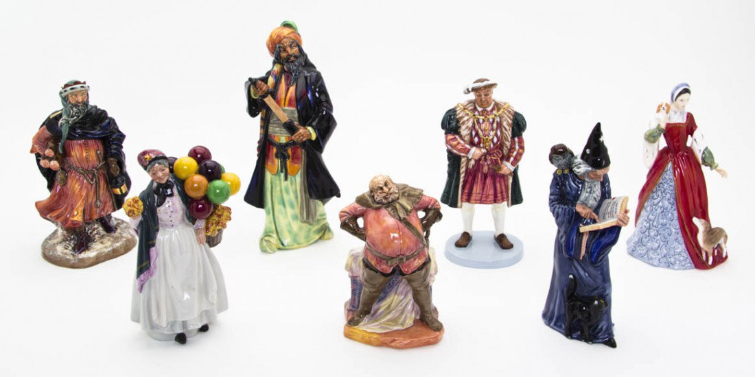 A Collection of Royal Doulton Figures, Height of : A Collection of Royal Doulton Figures, comprising Henry VIII, Anne Boleyn, Good King Wencelas, Bitty Pennyfarthing, Falstaff, Blue Beard and the Wizard. Height of tallest 11 1/4 inches. Property from 