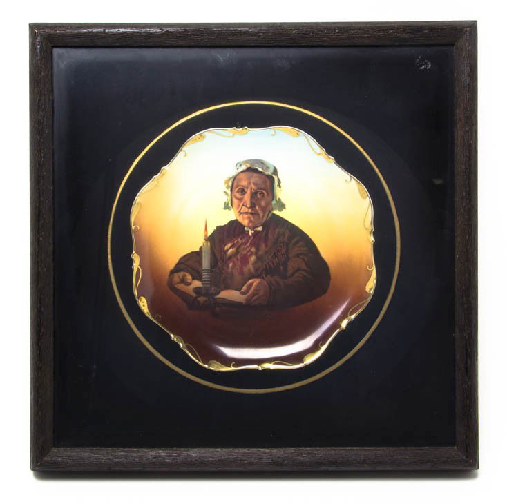 A Continental Porcelain Portrait Plate, Diameter: A Continental Porcelain Portrait Plate, depicting an elderly woman with a candle, set in a shadow box frame. Diameter 10 1/2 inches.