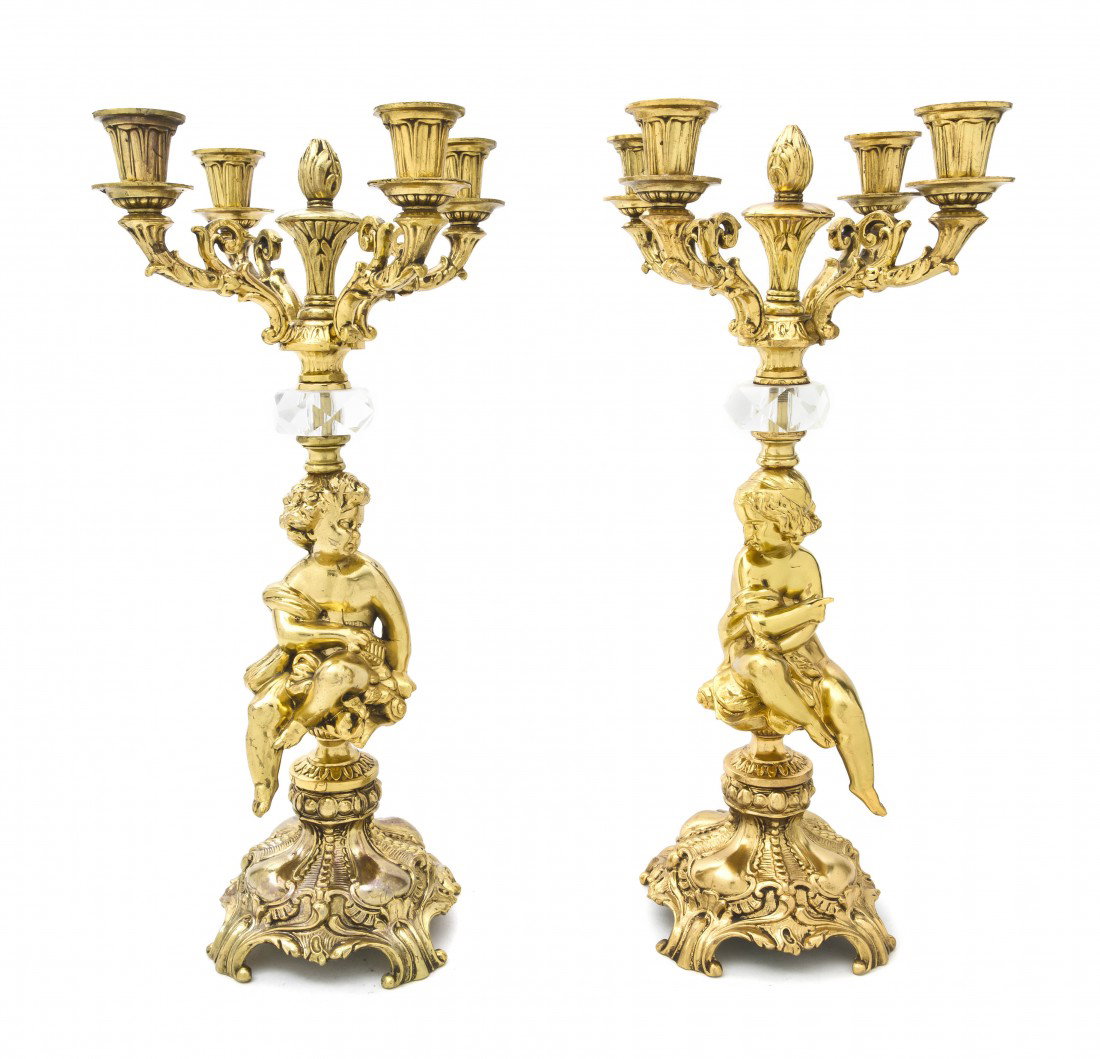 A Pair of Louis XV Style Brass Four-Light Candela: A Pair of Louis XV Style Brass Four-Light Candelabra, 20th century, each cast as a seated putto supporting the scrolling candle arms. Height 18 3/4 inches. Property from the Leon Brown Trust, U.S. Ban