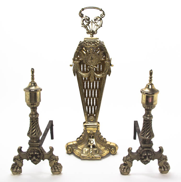 A Victorian Fan Form Brass Fire Screen, Height of: A Victorian Fan Form Brass Fire Screen, centered with a mask, together with two baluster form andirons. Height of first 28 inches. Property from the Leon Brown Trust, U.S. Bank, Trustee, Troy, Ohio