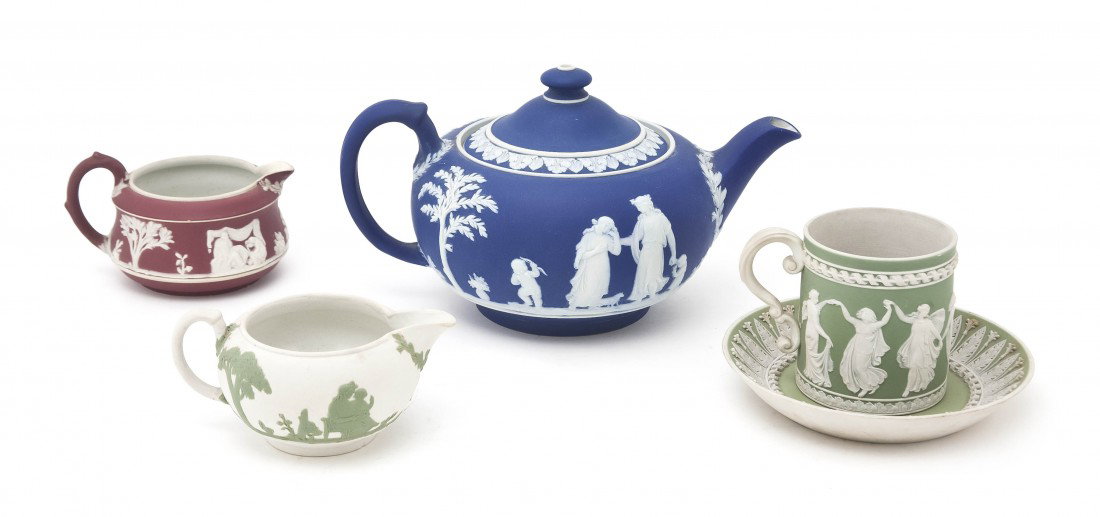 A Collection of Jasperware Tea Articles, Width of: A Collection of Jasperware Tea Articles, comprising a white on blue teapot, a white on red creamer, a green on white creamer and a white on green cup and saucer set. Width of widest 8 1/2 inches. Prop