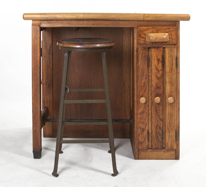 An American Pine Drafting Table, Height 36 3/4 x : An American Pine Drafting Table, having a rectangular partial tilt-top with a tubular paper stop, the base set with a series of paneled doors and a single drawer, together with an associated stool. He