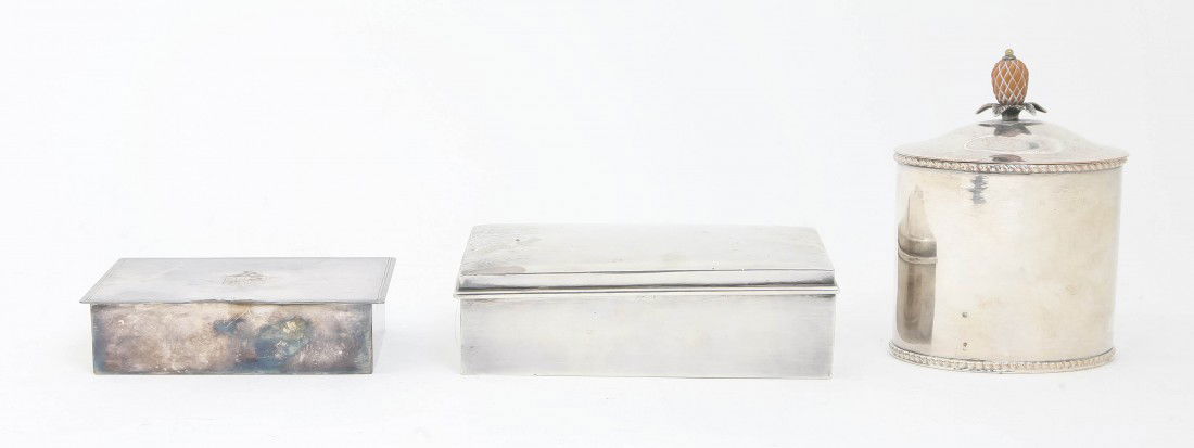 An American Sterling Silver Cigarette Box, Gorham: An American Sterling Silver Cigarette Box, Gorham, of rectangular form with wood liner, together with a silverplate example and an oval tea caddy. Width of first 5 3/8 inches. Property from the Estate