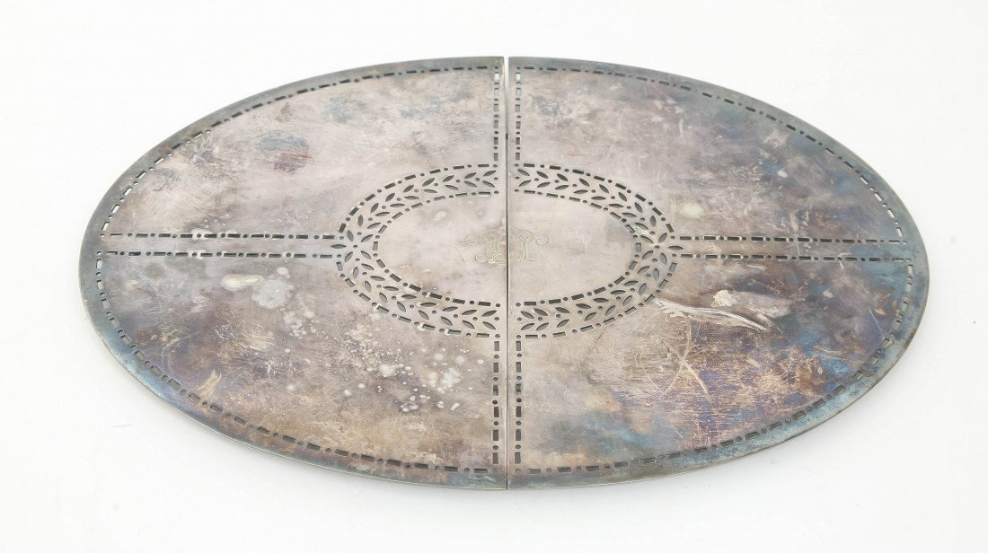 An American Silverplate Expandable Trivet, Tiffan: An American Silverplate Expandable Trivet, Tiffany & Co., of oval form with reticulated decoration centered with a monogram, raised on spherical feet. Width 13 1/8 inches closed. Property from the Est