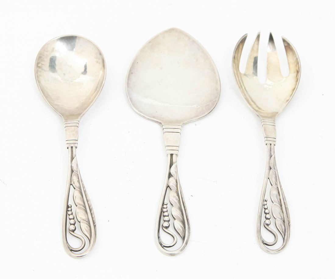 A Set of Three Danish Sterling Silver Articles, G: A Set of Three Danish Sterling Silver Articles, George Jensen, each having pierced stylized foliate handle, comprising a spoon, a fork and a pastry server, each stamped 42; approximate total weighable