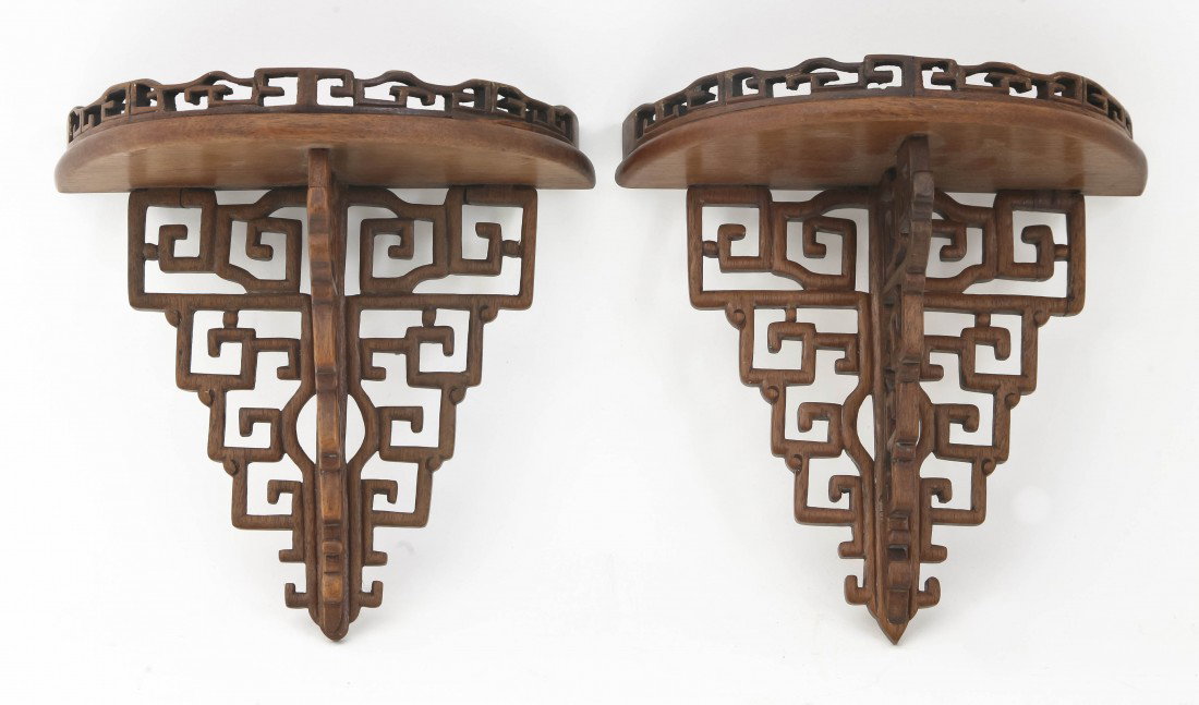 A Pair of Chinese Carved Hardwood Brackets, Heigh: A Pair of Chinese Carved Hardwood Brackets, of galleried demilune form, raised upon three pierce carved fins. Height 8 x width 8 x depth 4 inches. Property from the Collection of Nancy S. Westlake, Ch