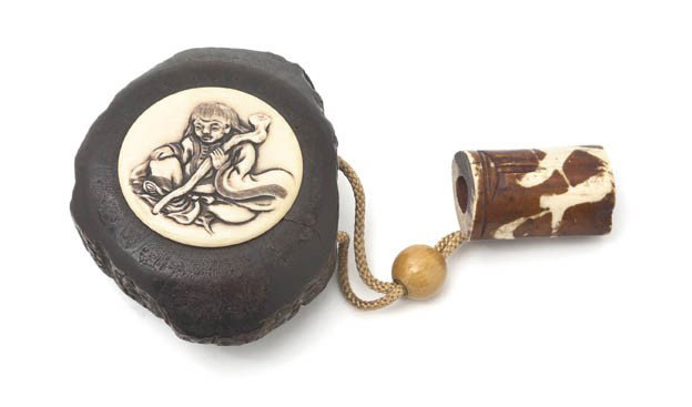 A Japanese Burlwood Tobacco Case, Width 3 1/2 inc: A Japanese Burlwood Tobacco Case, of a natural form, having a circular ivory lid with relief carving depicting a seated man with a staff, the case threaded with a woven cord having an ojime and ending