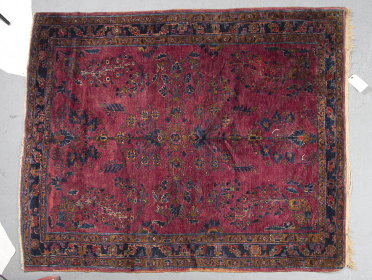 A Sarouk Wool Rug, 5 feet 6 inches.: A Sarouk Wool Rug, having a stylized foliate center medallion on a maroon ground within triple borders. 5 feet 6 inches. Property from the Leon Brown Trust, U.S. Bank, Trustee, Troy, Ohio
