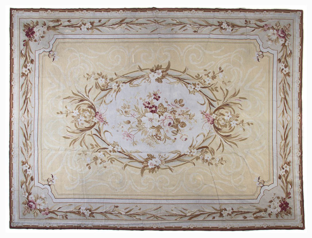 An Aubusson Style Wool Rug, Stark, 11 feet 7 inch: An Aubusson Style Wool Rug, Stark, having a foliate oval center medallion on an ivory field within conforming border. 11 feet 7 inches x 8 feet 8 inches.