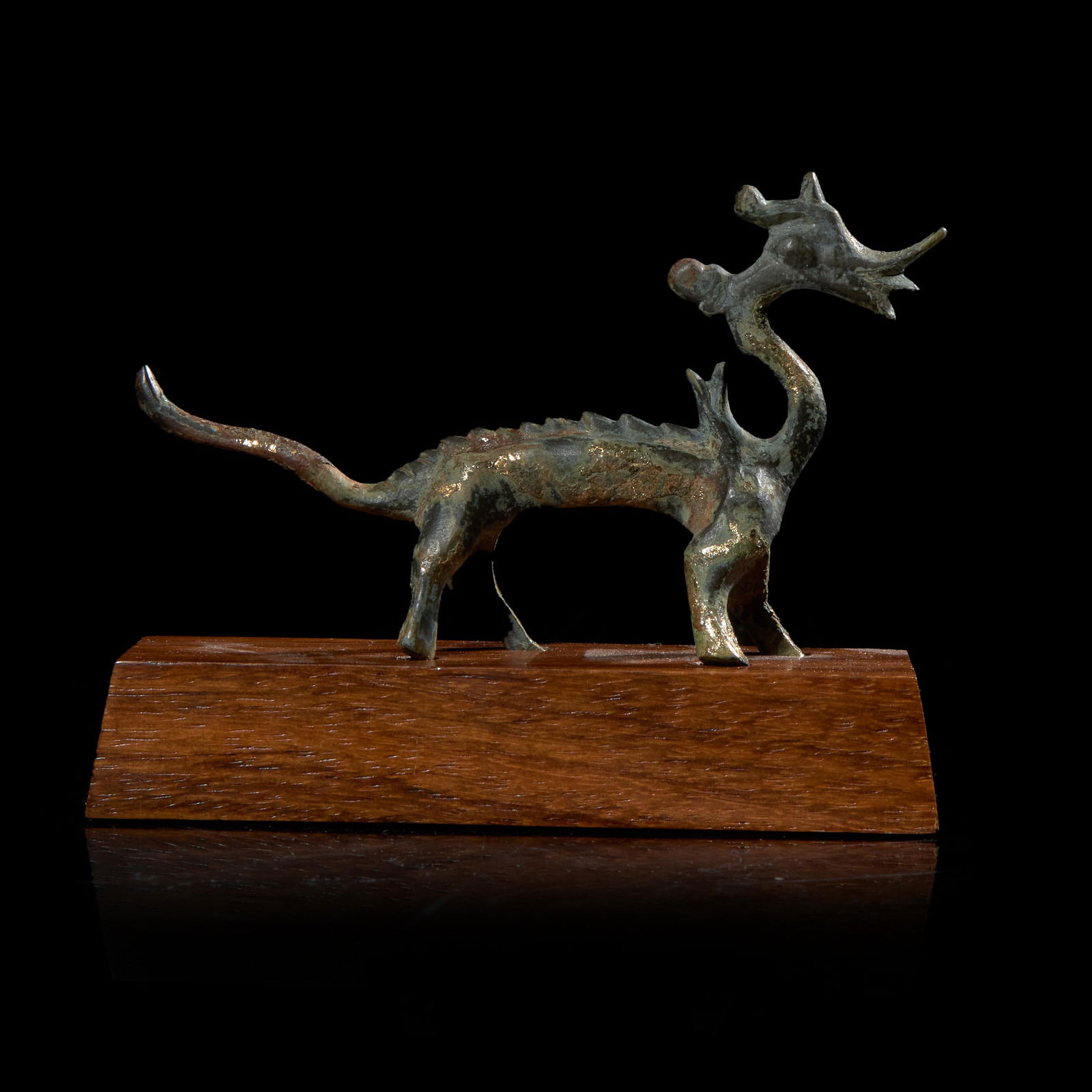 A small Chinese gilt-bronze figure of a striding dragon 铜鎏金行龙 Six (1 of 3)