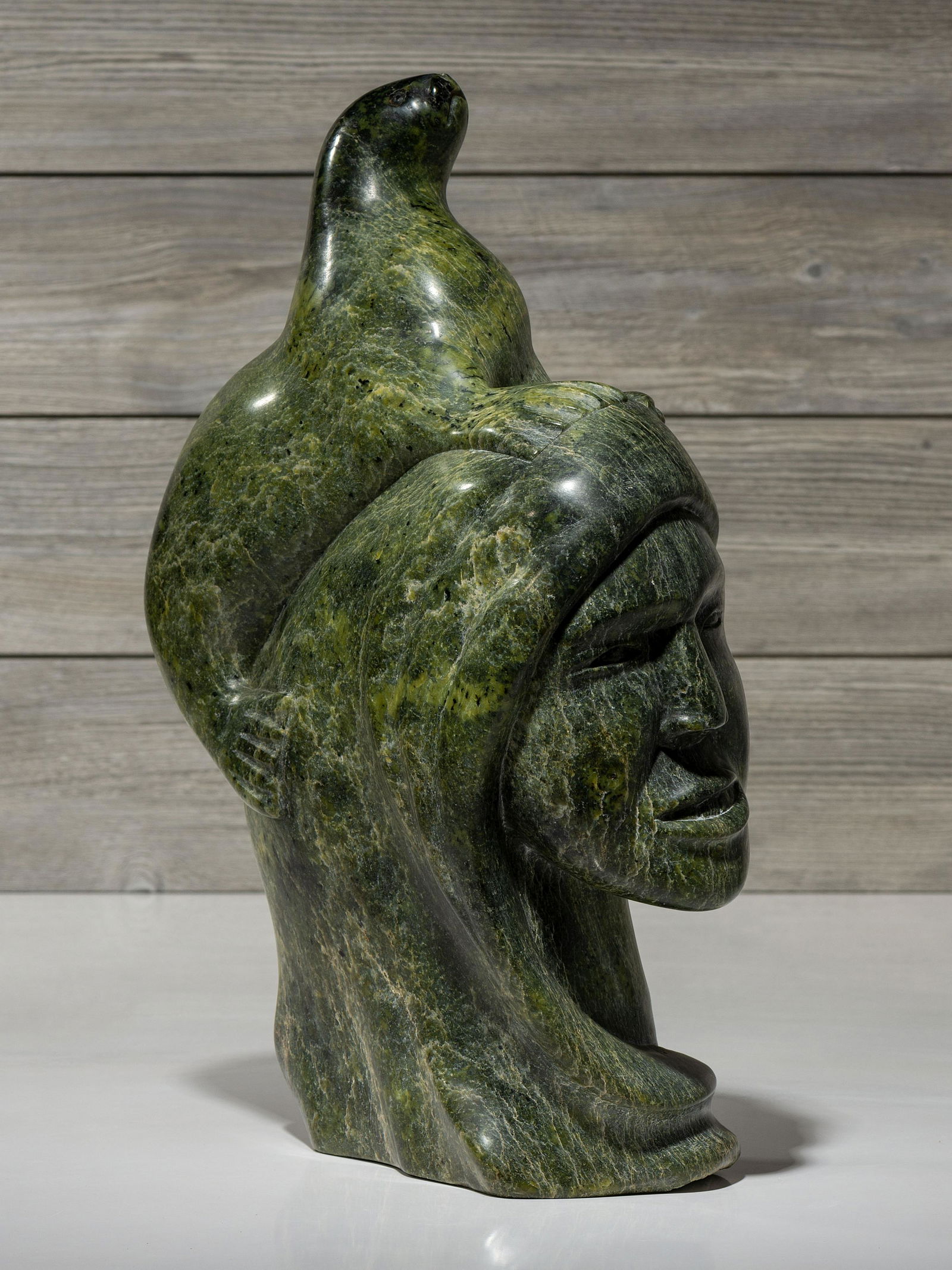 Kaka Ashoona (Kinngait [Cape Dorset], 1928-1996) stone sculpture, woman and seal (1 of 8)