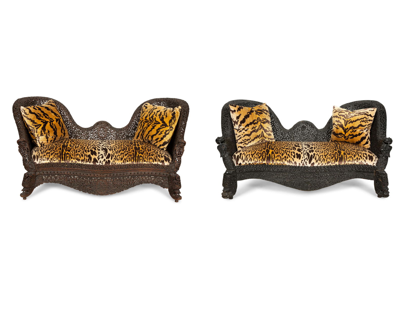 Two Similar Anglo-Burmese Carved Teak Settees: Two Similar Anglo-Burmese Carved Teak Settees 19th Century the seats with leopard velvet upholstery, together with two Scalamandre Tigre silk velvet cushions. Height 33 x width 69 1/2 x depth 32 1/2 i