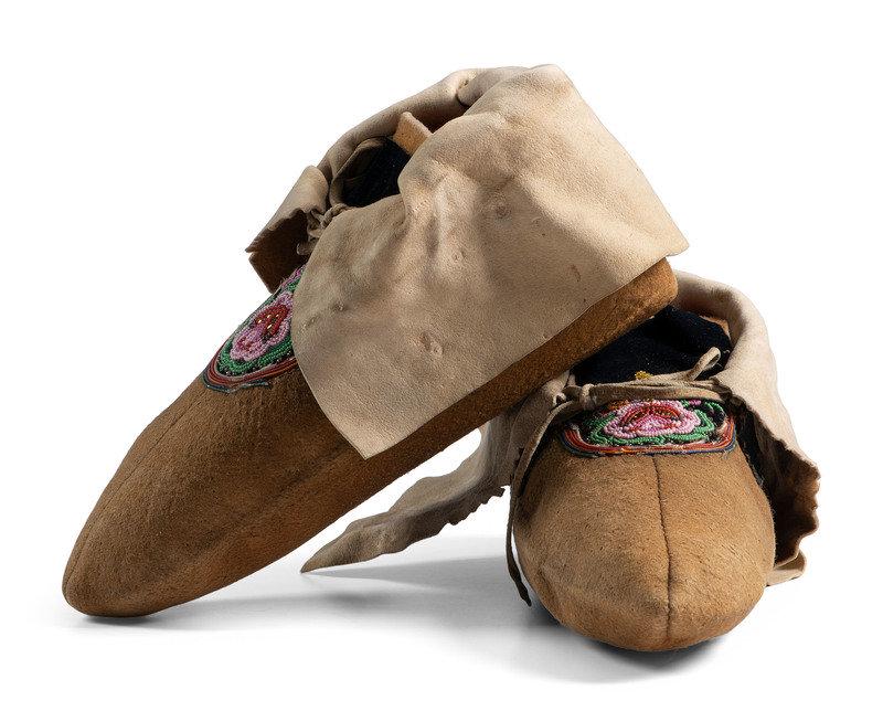 Cree Beaded Smoke Tanned Moccasins: Cree Beaded Smoke Tanned Moccasins ca 1900 thread-sewn on smoke tanned moose hide; vamps lined with black velvet and beaded with floral design length 10 inches This lot is