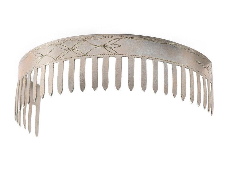 Menominee German Silver Hair Comb: Menominee German Silver Hair Comb first quarter 20th century with rocker engraved scrolling decoration height 1-5/8 inches x length 5-1/2 inches This lot is located in Cincinnati