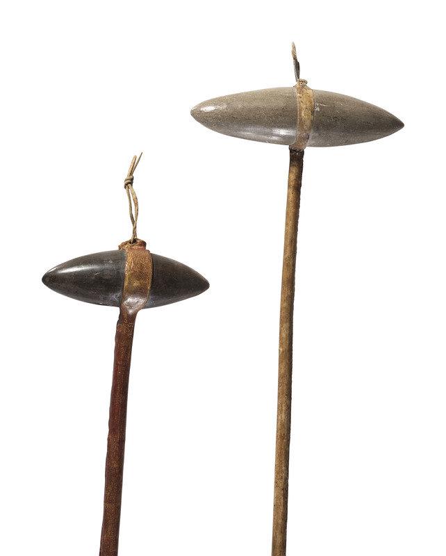 Plains Stone Clubs: Plains Stone Clubs fourth quarter 19th century lot of 2, includes:a club with a haft coated in red pigmentlength 21-1/2 inchesanother with an elongated conical head<