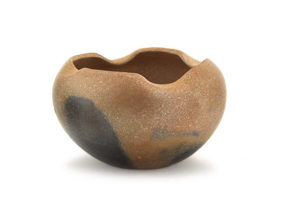 A Taos Micaceous Clay Bowl, Height 4 x diameter 6: A Taos Micaceous Clay Bowl, having a scalloped edge and fire cloud decoration. Height 4 x diameter 6 1/2 inches.