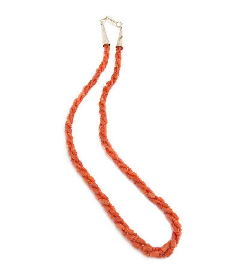A Santo Domingo Three Strand Twisted Coral Bead Ne: A Santo Domingo Three Strand Twisted Coral Bead Necklace, terminating in a silver clasp. Length 18 inches.