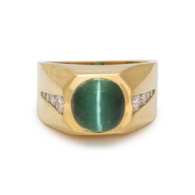 CAT'S EYE TOURMALINE AND DIAMOND RING: CAT'S EYE TOURMALINE AND DIAMOND RING Containing one round cabochon cat's eye tourmaline measuring approximately 9.30-9.45 mm in diameter and 10 round brilliant cut diamonds weighing approximately 0.8