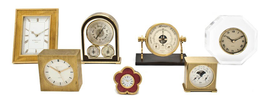 A Collection of Seven Table Clocks, Height of talle: A Collection of Seven Table Clocks, of various forms and sizes, two enamel examples retailed by Kitney & Co., a Swiss clock retailed by Tiffany & Co., three barometer examples and an octagonal lucite 