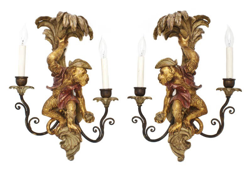 A Pair of Venetian Rococo Style Painted and Parcel: A Pair of Venetian Rococo Style Painted and Parcel Gilt Two-Light Sconces, each decorated with a monkey in a red jacket seated upon a scroll before a palm tree, flanked by scrolling arms issuing the t