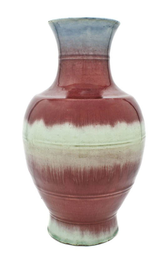 A Chinese Sang de Boeuf Porcelain Vase, Height of: A Chinese Sang de Boeuf Porcelain Vase, together with two flambe glazed conical shaped shallow bowls, and an Asian green glazed earthenware teapot. Height of tallest 16 inches. Property from the Colle